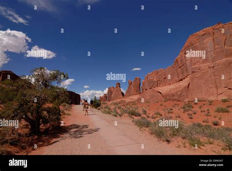 Tourists At The North And South Window Section Of Arches National Park