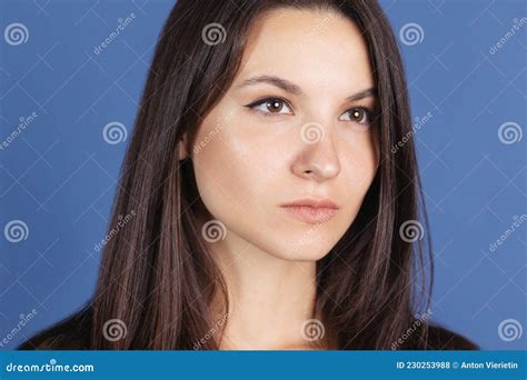 Close Up Portrait Of Beautiful Woman Looking Away Isolated Over Blue