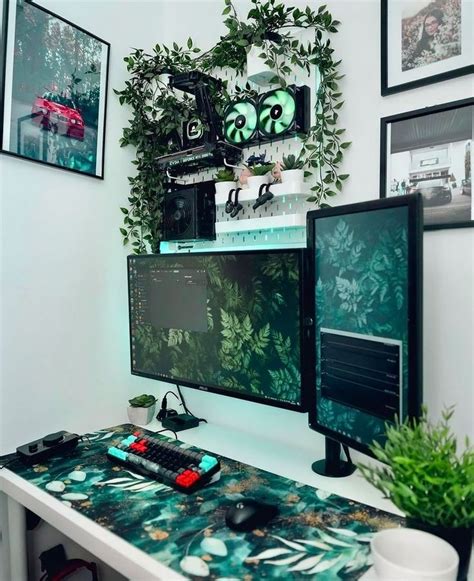 Two Computer Monitors Sitting On Top Of A Desk Next To A Keyboard