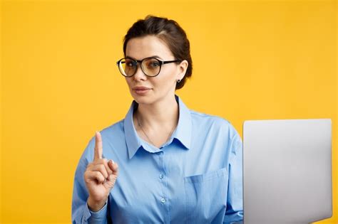 Premium Photo Pretty Businesswoman In Glasses Holding Her Finger Up And Using Computer