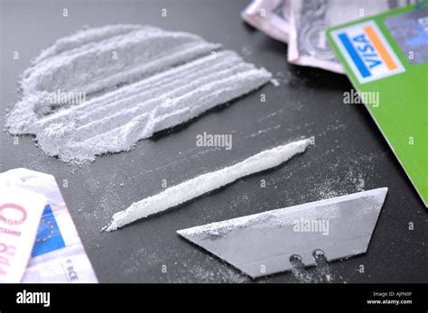 a line of cocaine and drug paraphernalia including a credit card and ...