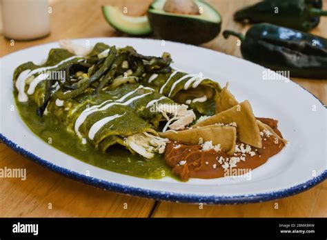 Green Enchiladas Mexican Food With Tomato Sauce And Cheese In Mexico