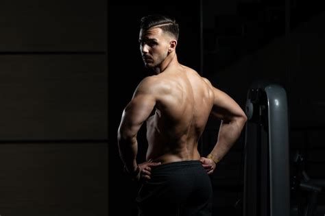 Premium Photo Muscular Man Flexing Back Muscles Pose