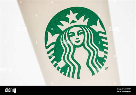 Logo of a Starbucks on a paper Coffee cup. Starbucks is the largest coffeehouse company in the ...