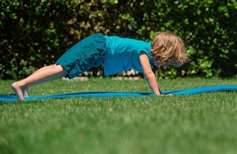 Premium Photo | Kids yoga child doing yoga exercises boy yoga outdoor