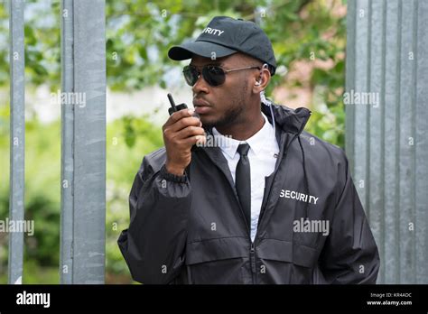 Security Guard Using Walkie Talkie Stock Photo Alamy