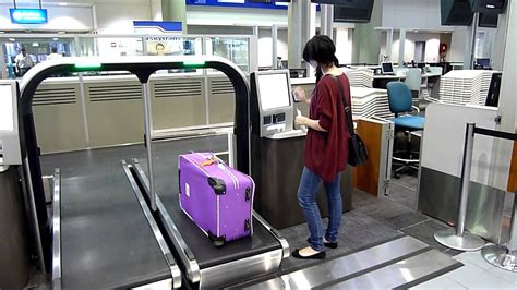 Passengers Using Self Service Bag Drop At Brisbane Domestic Airport