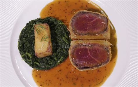 Beef Wellington with Spinach and Fried Potatoes.Close Up Stock Photo ...