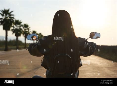 Woman Riding Motorcycle At Sunset Back View Stock Photo Alamy