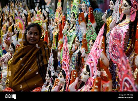 An Indian Vendor Waits For Customers As She Sells Clay Images Of