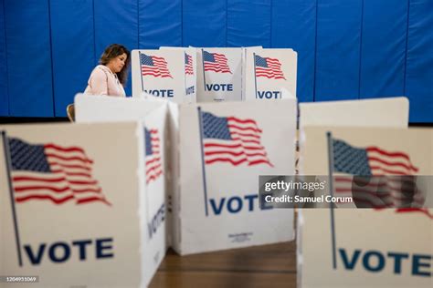 A Woman Marks Down Her Vote On A Ballot For The Democratic News