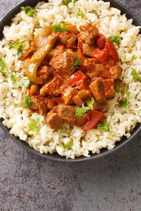 Porkolt Hungarian Beef Paprika Stew Served With Noodles Closeup On The