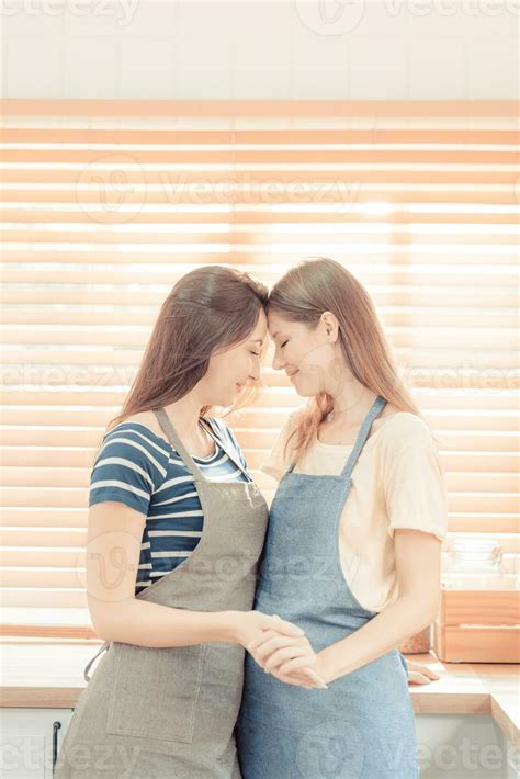 Lesbian Couple Together Indoors Concept Lesbian In The Kitchen Young Women Are In A Mutual