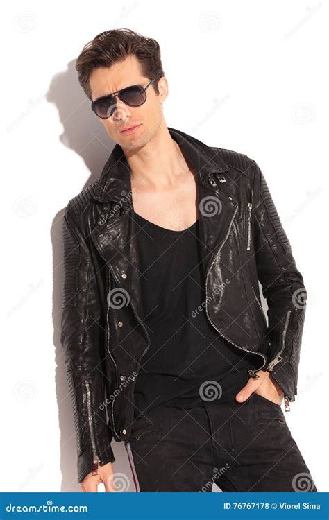 Relaxed Fashion Man In Leather Jacket And Sunglasses Stock Photo