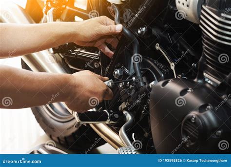 Mechanic Hold Hex Key Wrench Working On Motorcycle At Motorbike Garage