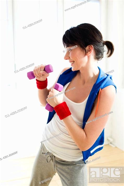 Woman lifting weights indoors, Stock Photo, Picture And Royalty Free ...