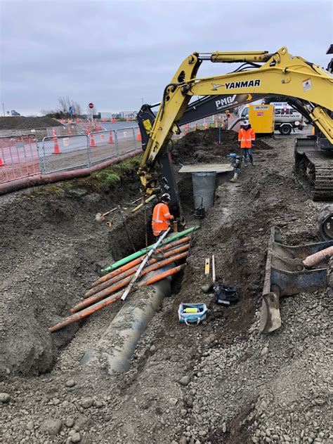 Installing manhole and piping stock water race under services - PMG