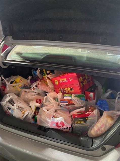 The Trunk Of A Car Filled With Bags And Food In It S Back Compartment