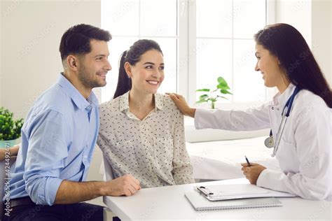 Female Doctor Consulting Young Couple Patients In Fertility Clinic