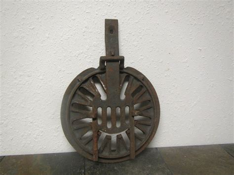 an old cast iron grate on the floor in front of a white wall and tile floor