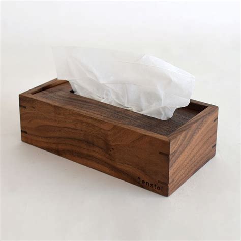 A Tissue Dispenser Made Out Of Wood And White Paper In It S Holder