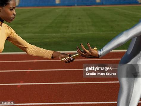 Women Athletes Passing The Baton During Relay Race Photos And Premium High Res Pictures Getty