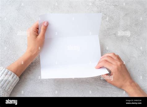 Girls Hands Holding Sheet Of Paper Stock Photo Alamy