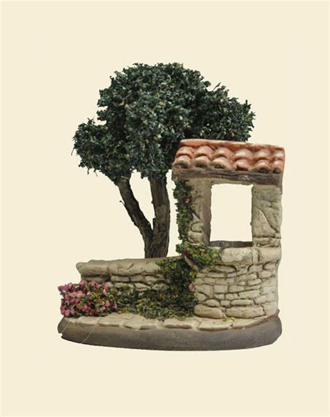 A Small Tree Sitting On Top Of A Stone Wall