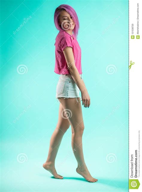 Slim Fit Sporty Active Woman In Denim Shorts Looking At Camera Isolated