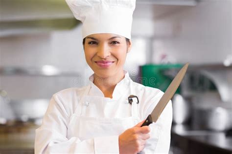 Portrait Of A Confident Female Cook Holding Knife Stock Photo Image