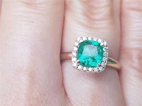 Halo Cushion cut Emerald and Diamond Ring