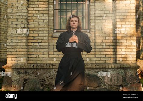 Christian priest with cross standing by the church Stock Photo - Alamy