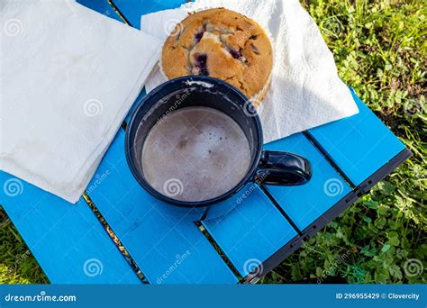 Hot Chocolate With Whip Cream And Muffins On A Small Camp Table Stock