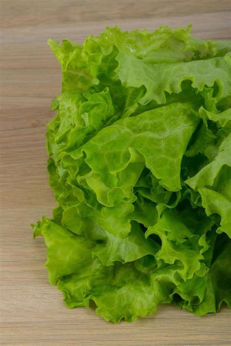 Salad leaves on wooden background 12876085 Stock Photo at Vecteezy