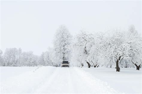 Premium Photo | Rear view of the car on a snowy country road rural ...