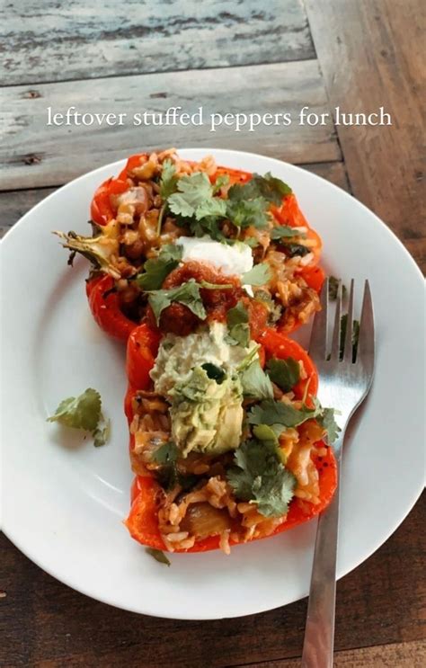 A White Plate Topped With Stuffed Bell Peppers Covered In Toppings Next