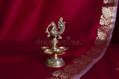 Indian Traditional Bronze Oil Lamp In The Form Of A Bird On A Blue Sari