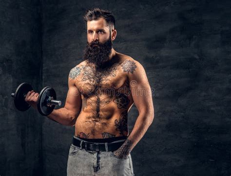 Shirtless Bearded Male With Tattooed Torso Doing Workout With D Stock