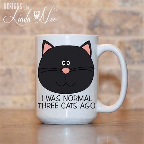 A White Coffee Mug With A Black Cat On It S Face And The Words I Was