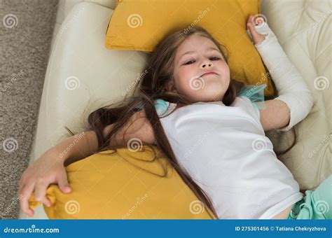 Child With A Cast On A Broken Wrist Or Arm Smiling And Having Fun On A