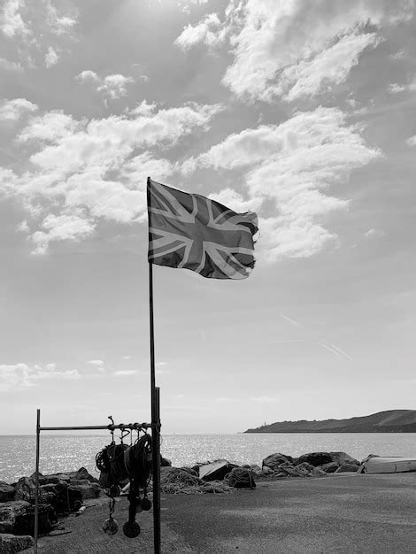 Premium Photo Flag On Beach Against Sky