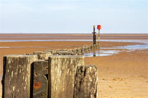 Wooden Groyne On Cleethorpes Beach With Wind Turbines In The Distance