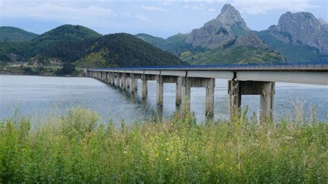 Premium Photo | Riaño bridge with the reservoir and mountains on a ...