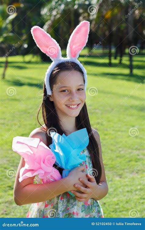 Smiling Teen Girl With Rabbit Ears Holding Easter Chocolate Eggs Stock