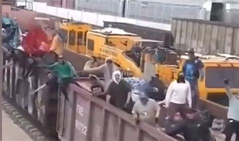 Video shows migrants clinging onto train heading for US border as ...