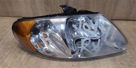 04857700AC REFLEKTOR PRAWY DODGE CARAVAN Lampy Przednie Omoto Pl