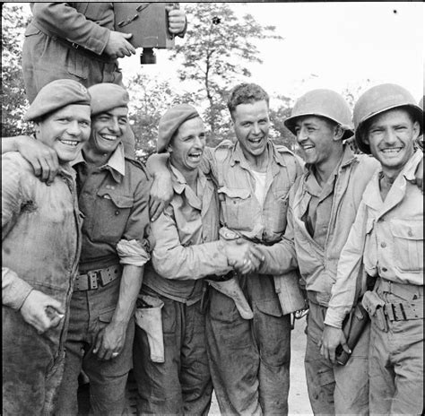 British and American soldiers joyfully pose for a picture, when the two ...