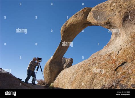man photographing rock arch  alabama hills recreation area eastern