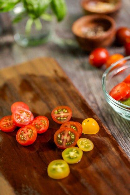 Premium Photo Slicing Heirloom Cherry Tomatoes On Wood Cutting Board