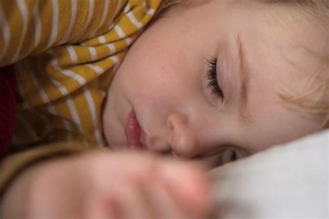 Premium Photo Peaceful Adorable Baby Sleeping On A Bed At Home